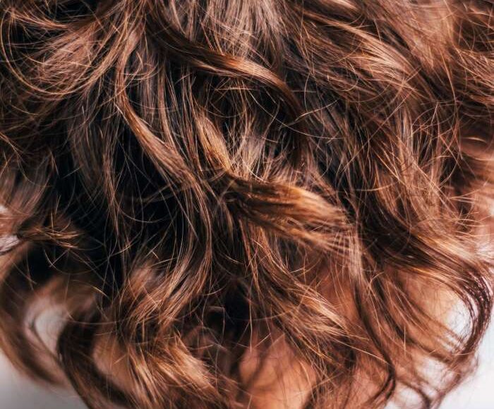 Dark brown curly hair.